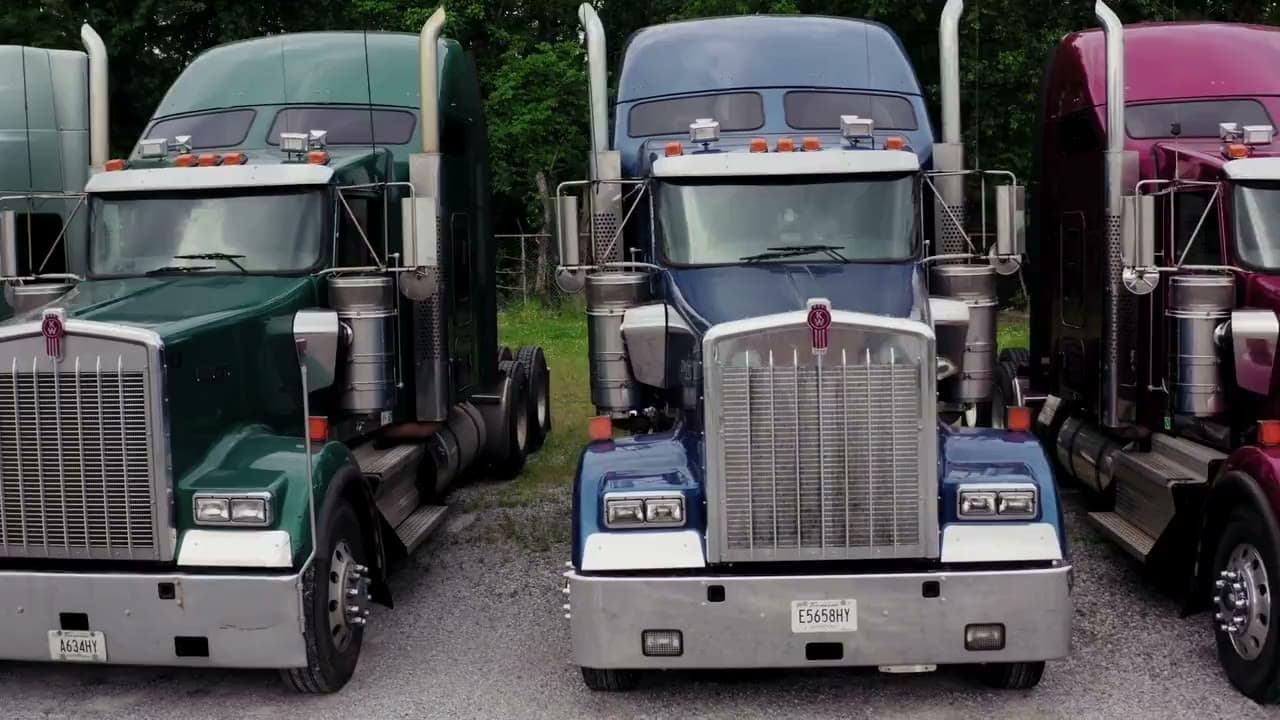 A fleet of trucks parked at a logistics terminal